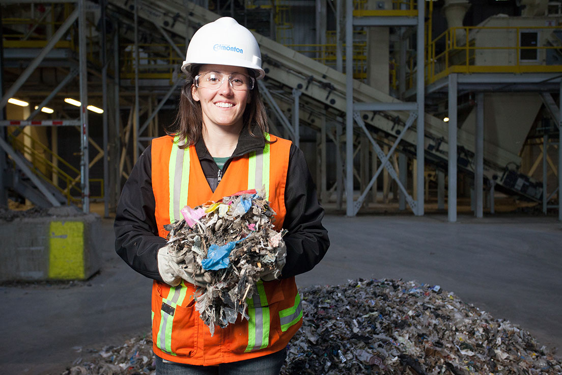 City promotional photograph showing an employee holding shredded refuse-derived fuel inside a processing facility