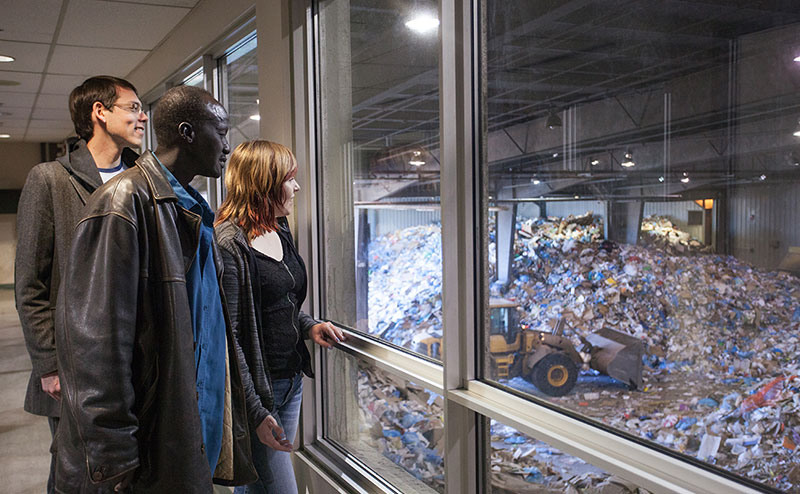 Visitors observe waste-handling operations through a viewing window at the Edmonton Waste Management Centre